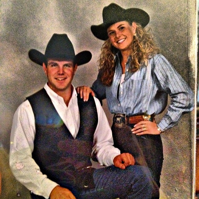 Lea Penick in a black hat, blue shirt, and black pant posing with her elder brother.